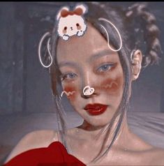 a woman with red lipstick and white teddy bear nose piercings on her head is shown in an artistic photo