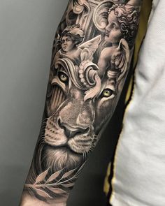 a man's arm with tattoos on it and an image of a lion in the background