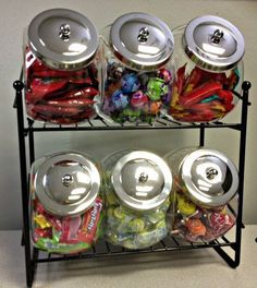 a metal rack filled with lots of different types of food and drinks on top of a table