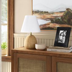 a table with a lamp and pictures on it