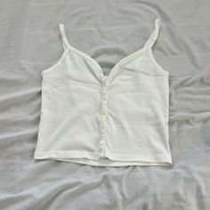 Brandy Melville Tank Top One Size Condition: Nwot Color: White Details : - Button-Down - Waist Length - Sweetheart Neckline - Versatile Piece, Can Be Styled Various Ways For Various Seasons Extra: - I Ship Between 1-2 Days Casual Cotton Tank Top With Buttons, White Cotton Tank Top With Buttons, White Cotton Buttoned Tank Top, V-neck Cotton Tank Top With Buttons, Cotton V-neck Tank Top With Buttons, Casual White Buttoned Tank Top, White Buttoned Top For Everyday Wear, White Cotton Tank Top With Button Closure, White Button-up Tank Top For Spring