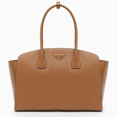 Large Caramel-Coloured Leather Shopping Bag From Prada Featuring An Interior Flat Zipped Pocket, Two Top Handles With Strap Detail, Contrasting Front Lettering Logo And Gold-Tone Metal Hardware. Width 38.5 Cm X Height 27.5 Cm X Depth 16 Cm Handle Drop: 18 Cm Size Type: Int Material: Leather Sku: 2f-1bg514ooo2egm/O_prada-F03bh_100 Welcome To The Official Luosophy Poshmark Closet! Luosophy Is A Luxury Brand Reselling Company Founded In San Diego, Ca From 2016. All Our Products Are Imported From It Lettering Logo, Black Leather Handbags, Louis Vuitton Shoulder Bag, Leather Cleaning, Colored Leather, Metal Hardware, Bag Women, Chanel Handbags, Luxury Items