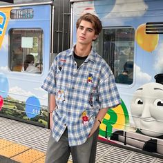 Add a pop of personality to your wardrobe with our Cartoon Embroidered Plaid Shirt! This playful shirt features an embroidered cartoon design on a classic plaid print, offering a unique and fun twist to a timeless style. Perfect for those who don't take themselves too seriously! Features: -66%Polyester 34%Cotton -Stand Collar -Full zip closure -Letter Graphic -Regular fit -High Street Style Cute Blue Button-up Shirt, Casual Embroidered Collared Shirt, Casual Collared Gingham Shirt, Casual Gingham Collared Shirt, Light Blue Cotton Embroidered Shirt, Light Blue Embroidered Cotton Shirt, Preppy Short Sleeve Blue Shirt, Preppy Blue Short Sleeve Shirt, Summer Casual Plaid Shirt