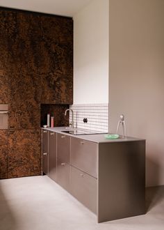 a modern kitchen with stainless steel cabinets and counter tops