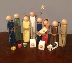 several wooden pegs are arranged on a table next to small boxes and magnets