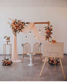 an image of a wedding ceremony setting with flowers on the table and chairs in front