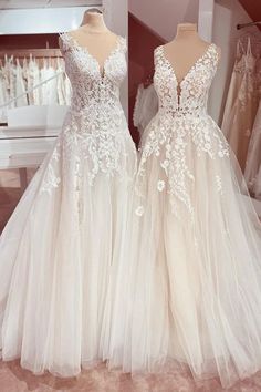 two wedding gowns on mannequins in a store