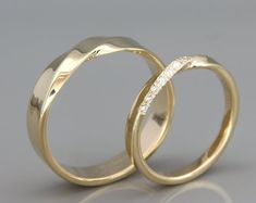 two gold wedding rings with diamonds on them