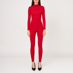 Elevate your style with this elegant long-sleeved fitted jumpsuit, perfect for any sophisticated occasion. Designed with sleek lines and a figure-hugging silhouette, this chic one-piece offers both comfort and a touch of class. Featuring a convenient back fastening zipper, it ensures a secure and flattering fit. Its form-fitting design accentuates your curves, while the long sleeves add a refined touch. Ideal for a night out or a special event, this timeless piece will turn heads on your night o Elegant Evening Bodysuit In Elastane, Elegant Evening Bodysuit With Second-skin Fit, Elegant Second-skin Bodysuit For Evening, Elegant Red Long Sleeve Jumpsuit, Chic Long Sleeve Jumpsuits In Elastane, Chic Fitted Elastane Jumpsuits And Rompers, Elegant Fitted Long Sleeve Jumpsuits And Rompers, Elegant Long Sleeve Winter Jumpsuits And Rompers, Elegant Winter Jumpsuits And Rompers With Long Sleeves