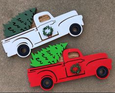 two cardboard cars with christmas tree decorations on them