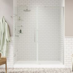 a white tiled bathroom with a walk in shower next to a chair and towel rack