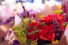 a bunch of flowers that are in some kind of paper bag on the table together