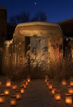 many lit candles in front of a building