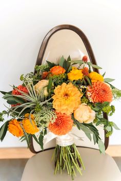 a bouquet of flowers sitting on top of a toilet