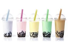 four different colored drinks with straws in each cup and on the other side are lined up