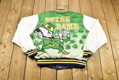 Check Out The Rest of Our Shop: https://www.etsy.com/ca/shop/Lostboysvintage  Pit to Pit: 25 inch Shoulder to Bottom: 24 inch Tag Size: XL Fits Like: TTS Minor Vintage Wear - No Major Flaws - Great Condition - Please See Pictures And Feel Free To Ask Any Questions!  Welcome to Lost Boys Vintage! We are a Toronto-Based online thrift store! Make sure to check out all the other items we have in stock as we list new items every week. Thank you for shopping with us and we hope to hear from you again! Retro Sports Varsity Jacket With Graphic Print, Retro Varsity Jacket With Graphic Print For Sports, Retro Graphic Print Varsity Jacket For Sports, Retro Varsity Jacket For Sports Season, Retro Varsity Jacket With Graphic Print, University Of Notre Dame, Notre Dame University, Lost Boys, Online Thrift