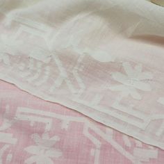 the pink and white fabric is laying on top of it's own pillow case