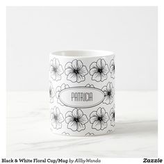 a black and white floral cup with the name patricaa on it's side