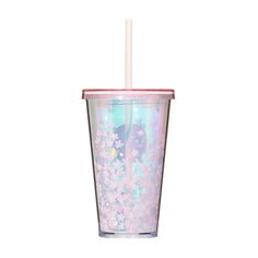 a pink and blue cup with a straw in the middle is filled with flowers, stars and confetti