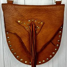 Bohemian Girls On A Motorcycle Brown Leather Studded Crystals Fringe Bag Hand Made In The Usa! This Was Built With Natural Buffalo Leather, Which Has Variations In Color, And Scars, Due To The Skin Being Irregular. Brass Pyramid Design Stud Detail. Deerskin Fringe. Hand Made And One Of A Kind. Strap Is 1” Wide With A 24” Drop, Bag Measures 11” By 12”. New Retail Price Was $450. New Without Tags Condition! I Have Two Other Different Bags Made By The Same Designer Right Now, Including The Black Ba Brown Satchel Saddle Bag For Festivals, Brown Leather Saddle Bag For Festival, Leather Bags With Adjustable Strap For Festivals, Leather Satchel Saddle Bag For Festivals, Leather Satchel With Adjustable Strap For Festivals, Chic Festival Bag With Adjustable Strap, Bohemian Leather Shoulder Bag, Leather Pouch Shoulder Bag For Festivals, Bohemian Crossbody Saddle Bag For Daily Use