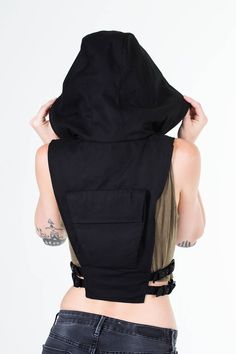 Ninja Kombat Hooded Crop Top Vest in Jet Black Canvas One part haute couture streetwear and two parts assassin, this leather harness vest invites intrigue and mystery, and mercilessly slays everything and everyone in it's path. Featuring a utilitarian pocket on the back, a zip closure front and adjustable side straps to keep in tune with a refined and foxy silhouette, be forewarned that when you wear this, you're going to turn heads ( and maybe crack some necks ). Shrinking violets need not appl Techwear Crop Top, Couture Streetwear, Custom Outfits, Tech Wear, Hooded Crop Top, Techwear Fashion, Dr Closet, Leather Bra, Crop Vest