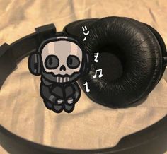 a pair of headphones with a skull sticker on it's earbands