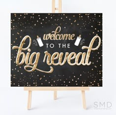 a black and gold sign with the words welcome to the big reveal written on it