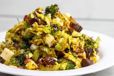 a white plate topped with broccoli and raisins