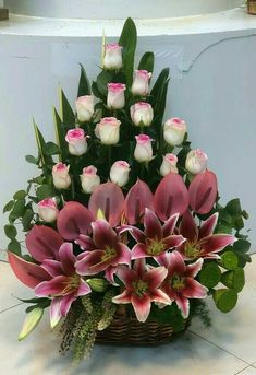 a basket filled with lots of pink and white flowers