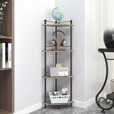 a corner shelf in the corner of a room with books and other items on it