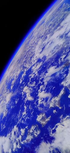 the earth as seen from space with clouds and blue sky