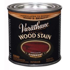 a can of wood stain on a white background