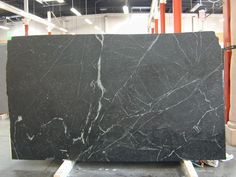 a large black marble slab in a warehouse