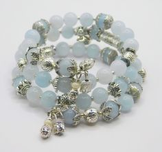 Created with Aquamarine Gemstone 8mm beads combined with silver plated metal beads,bead caps and charms on memory wire. Silver Spiritual Rosary Bracelet With Gemstone Beads, Silver Beaded Bracelets With Natural Stones For Healing, Silver Bracelets With Natural Stones And Round Beads, Silver Charm Bracelet With Natural Stones For Healing, Silver Gemstone Beaded Bracelets, Silver Beaded Bracelets With Gemstone Beads, Silver Beaded Bracelet With Gemstone Beads, Silver Beaded Bracelets With 108 Round Beads, Silver Bracelets With Silver Beads For Healing