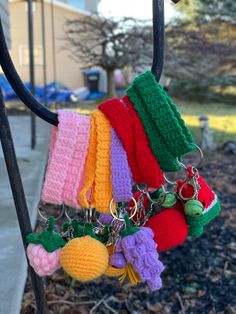 a bunch of knitted items hanging from a hook