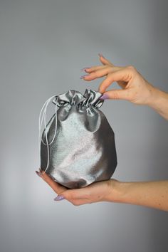 Elegant satin bag / money bag / purse ! Ideal for your wedding day, night out, party ,special occasion Made of beautiful silver grey bridal taffeta fabric. You can change colors Fabric : taffeta Lining : poliester Size : approx. 18 cm x 18 cm Silver Evening Bag With Dust Bag For Party, Silver Pouch Evening Bag As Gift, Silver Pouch Bag For Gift, Elegant Metallic Bag For Gift, Elegant Metallic Bag As Gift, Elegant Metallic Bags For Gifts, Elegant Gray Bag For Gift, Silver Clutch Evening Bag As A Gift, Silver Clutch Evening Bag Perfect As A Gift