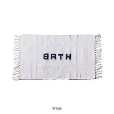 a white towel with the word bath written on it and blue letters in black ink