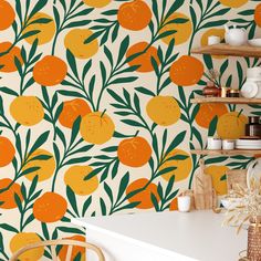 an orange and green wallpaper in a kitchen with white counter tops, chairs and shelves