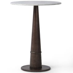 a round table with a wooden base and white marble top, on an isolated pedestal