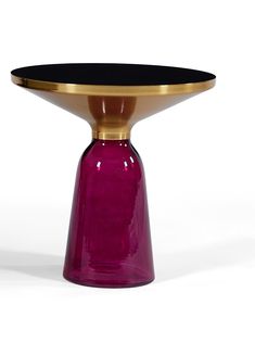 a purple glass table with gold trim around the top and bottom, on a white background