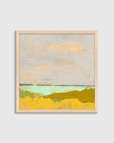 an abstract painting with yellow, green and grey colors on the wall above it is a white