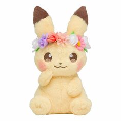 a small stuffed animal with flowers in its hair