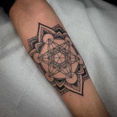 a man's arm with a geometric tattoo design on the left side of his arm