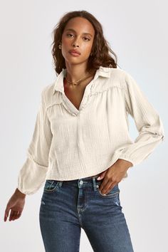 Oversized bell sleeve blouse with elastic cuffs, collared v-neck henley finished raw edges at yoke, placket & elbow seams. Solid color woven on relaxed fit. Edgy aesthetic, the natural laid-back fashion-forward statement of your staple.Body length from HPS: 21", Sleeve length: 21 1/2", Bust: 42" (Size Small) 100% COTTON Machine wash cold, Tumble dry low Imported Fall V-neck Top With Placket, Spring Henley Neckline Top With Placket, Spring Split Neck Blouse With Placket, Fall Cotton Blouse With Split Neck, V-neck Top With Placket For Fall, Cotton Split Neck Blouse For Fall, V-neck Top With Placket For Spring, Casual Henley Blouse For Fall, Casual Henley Neckline Blouse For Fall