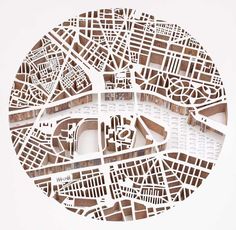 a paper cut out of the shape of a circle with buildings and streets in it