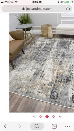 an area rug is shown on the floor in front of a couch and table with two chairs