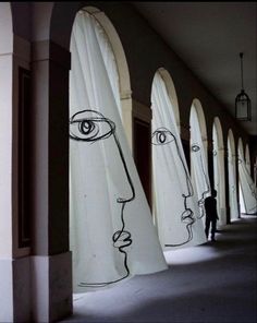 an art installation in the middle of a hallway with several large white sculptures on each side