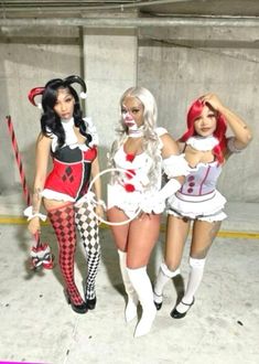 three women dressed in costumes standing next to each other