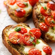 three pieces of bread topped with tomatoes and cheese