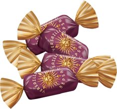 three chocolate candies with golden bows on them are sitting side by side in the shape of sunbursts